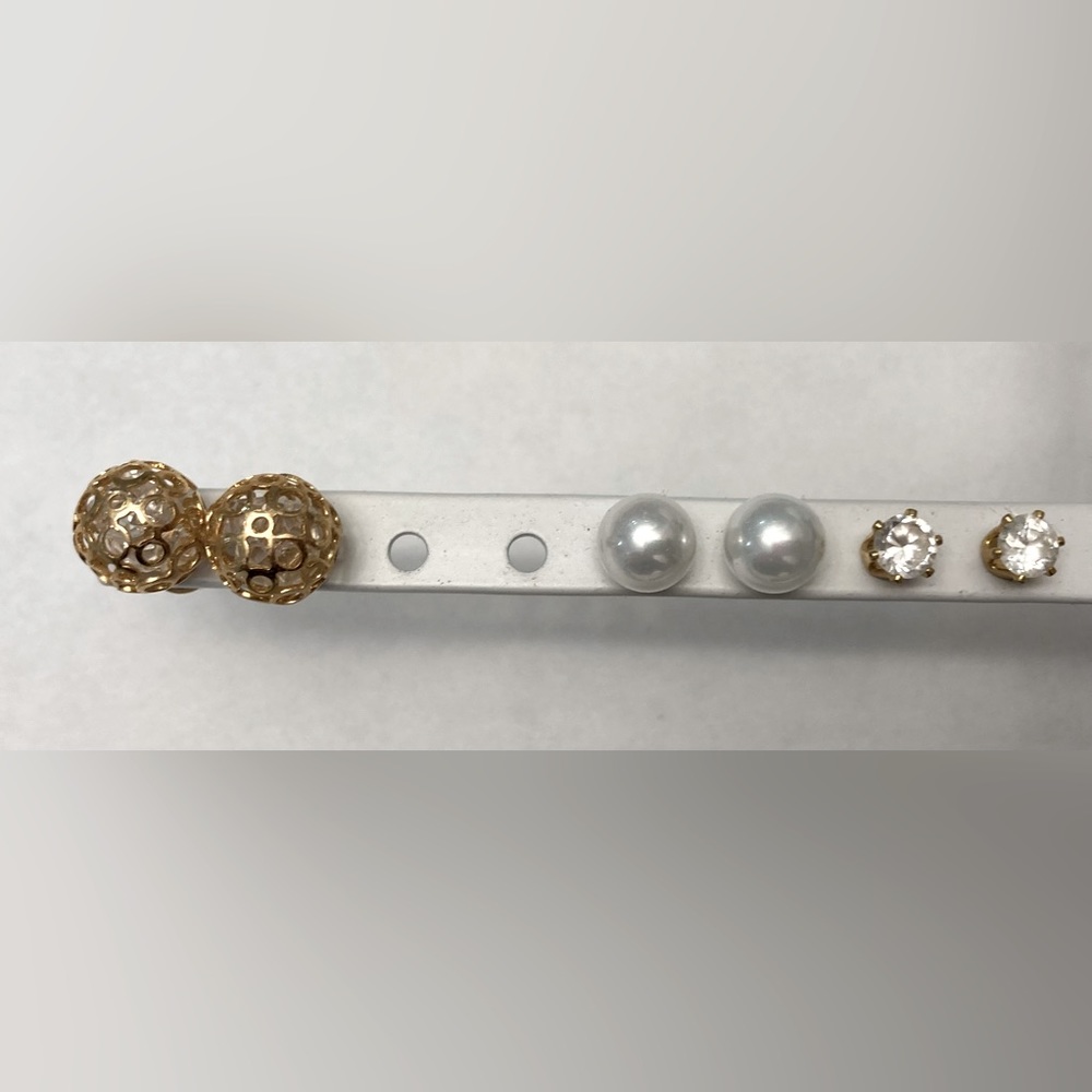 Three pairs of gold tone stud earrings: faux pearl, crystals in orb, round CZ